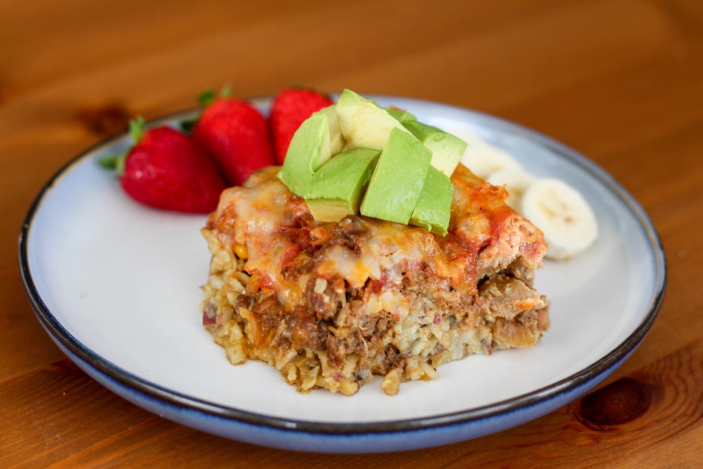 Mexican Egg Hash Casserole topped with avocado