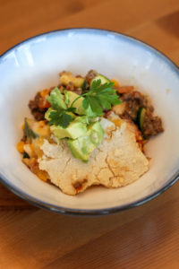 Bowl of mexican beef cobbler topped with cilantro