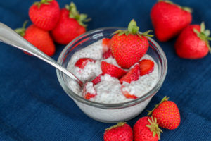 Small glass bowl filled with strawberry cheesecake chia seed pudding