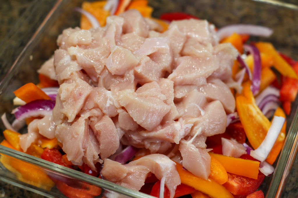 Glass dish of raw, unbaked chicken fajitas