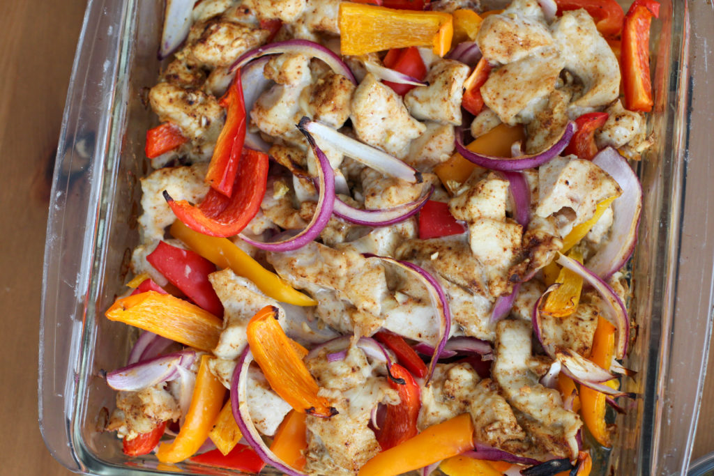 Glass dish of baked chicken fajitas