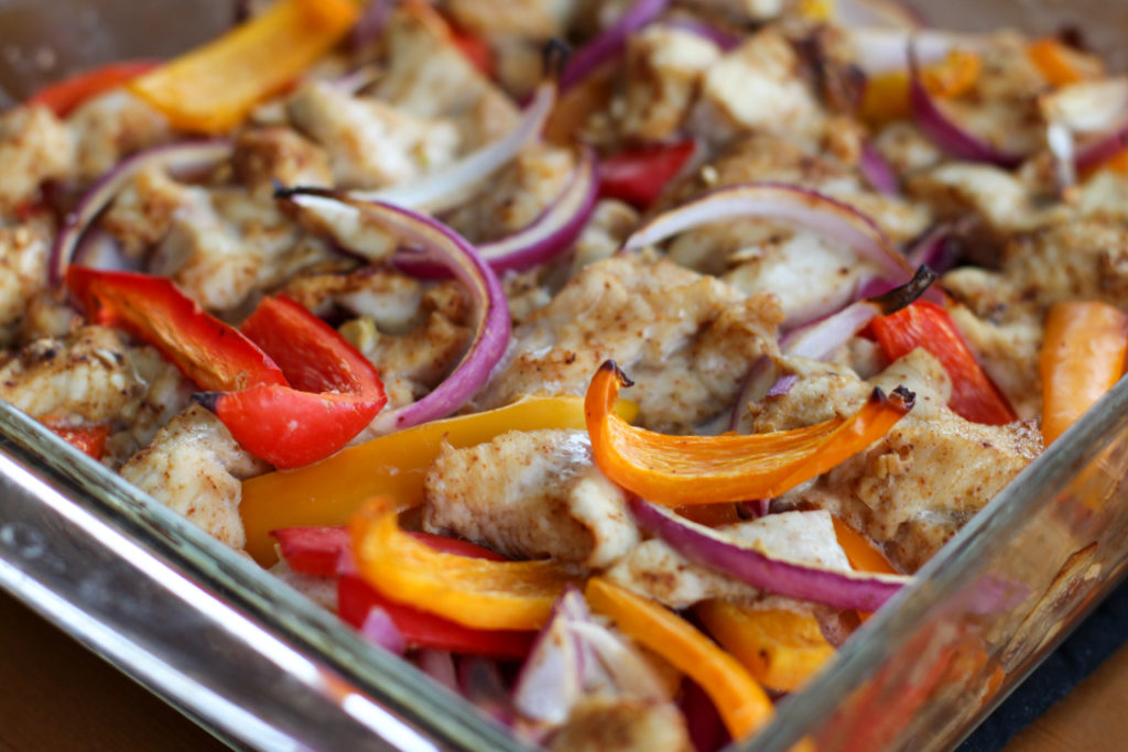 Glass dish of baked chicken fajitas