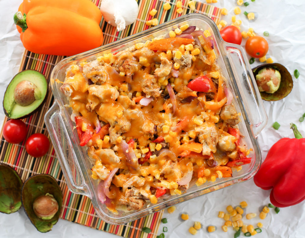 Pan of Easy Chicken Fajita Casserole surrounded with veggies