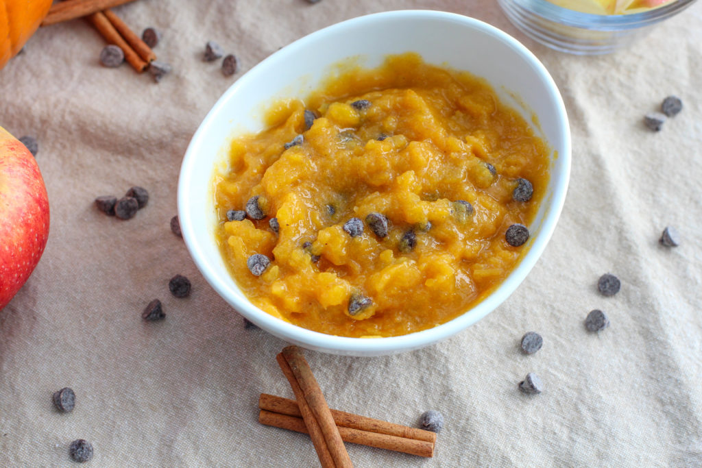 White bowl of pumpkin dip with chocolate chips