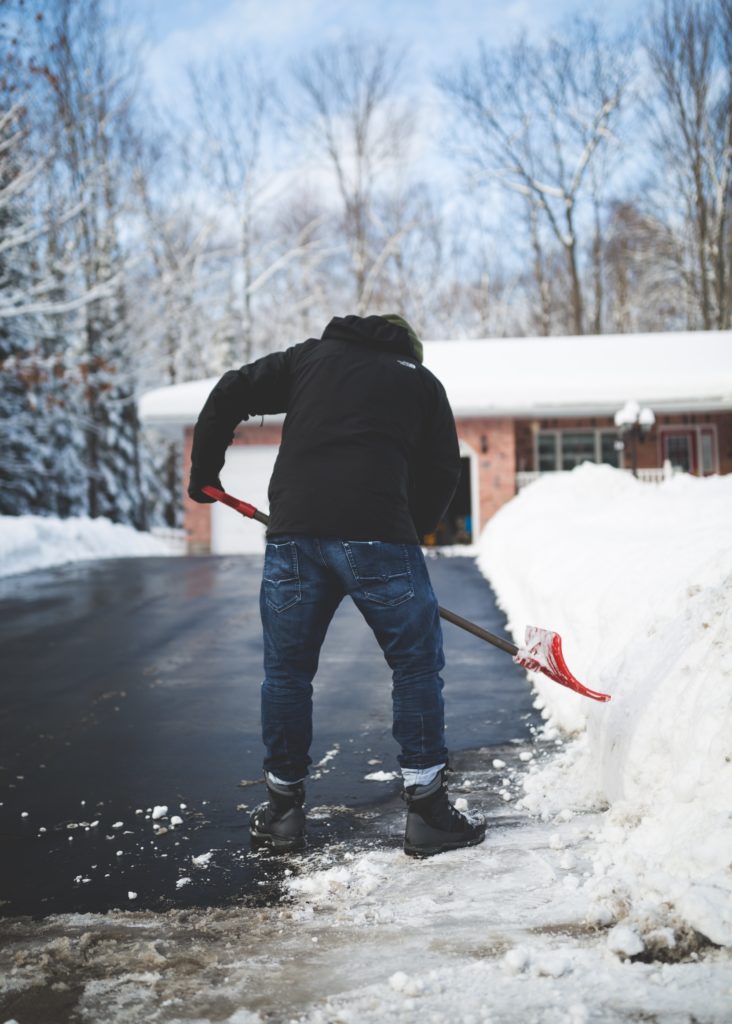 man shoveling snow on driveway - 5 love languages acts of service