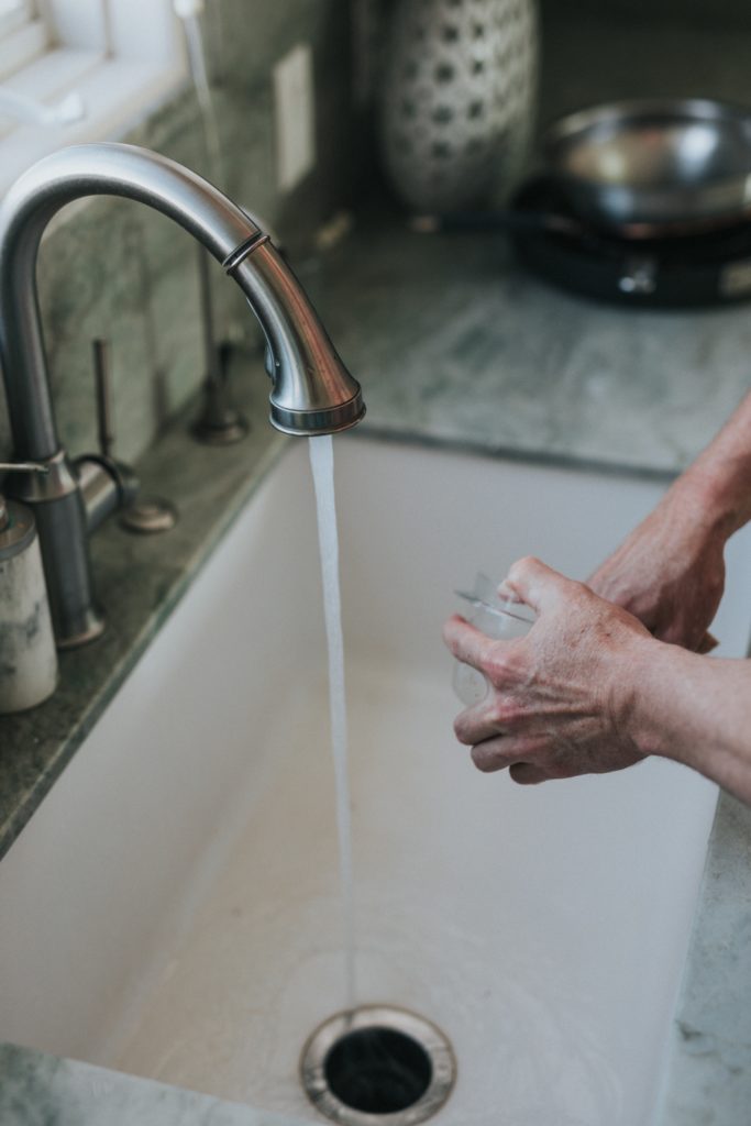 man washing dishes