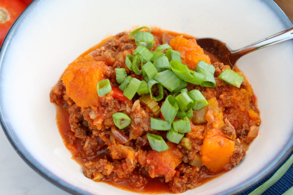 Bowl of butternut squash chili topped with green onion