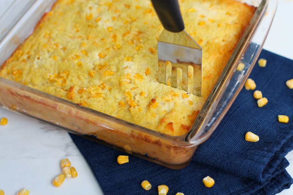 Server cutting into pan of cornbread