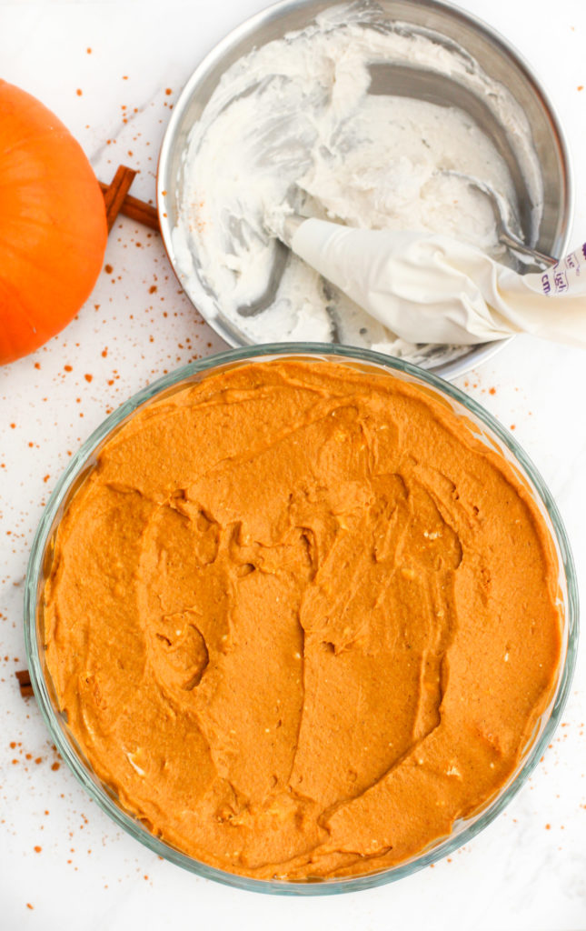top view of pumpkin layer showing with whipped cream bowl beside it