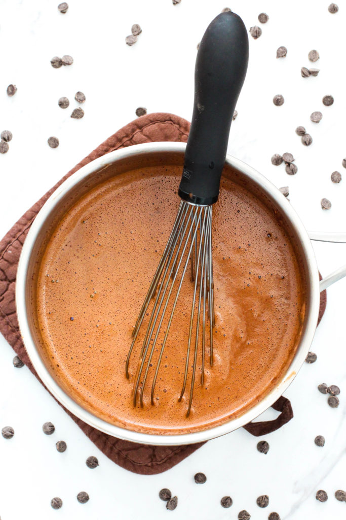 Pan of homemade hot chocolate with whisk