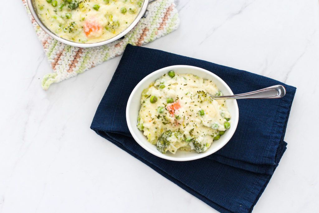 Pan and bowl of creamy vegetable soup