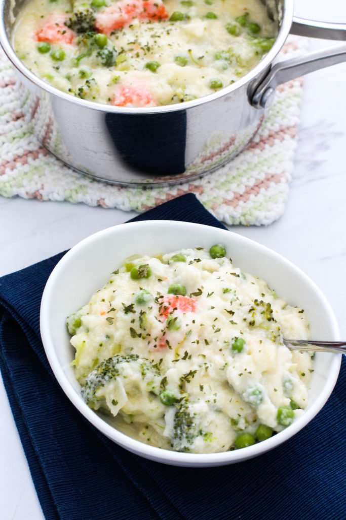 Pan and bowl of creamy vegetable soup