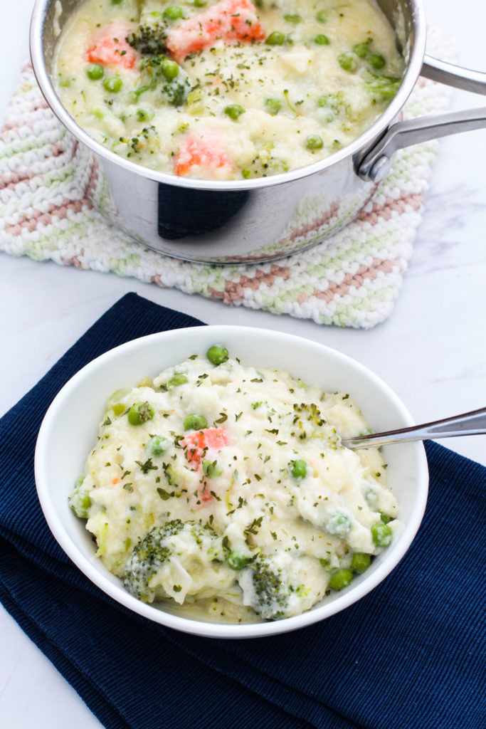 Pan and bowl of creamy vegetable soup