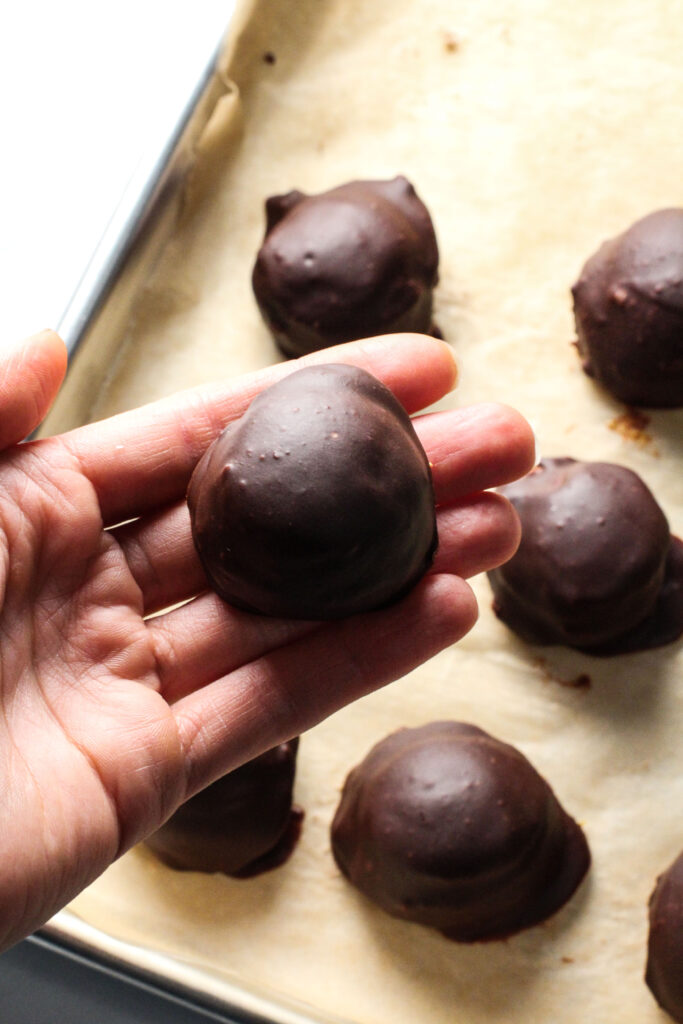 hand holding pumpkin pie truffle