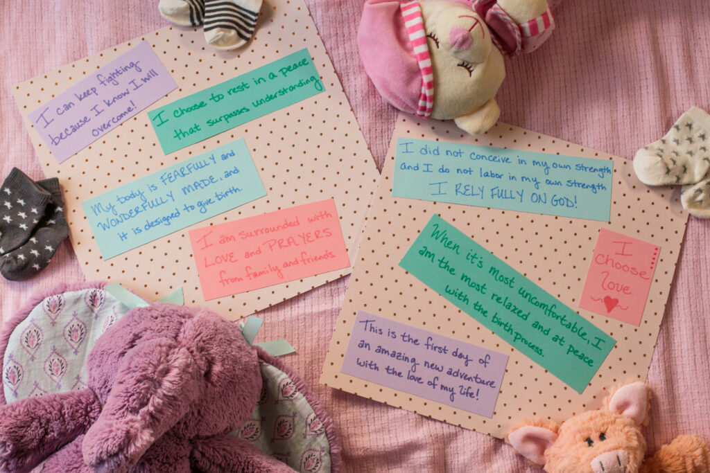 overhead view of scrapbook pages for a natural birth surrounded by baby items