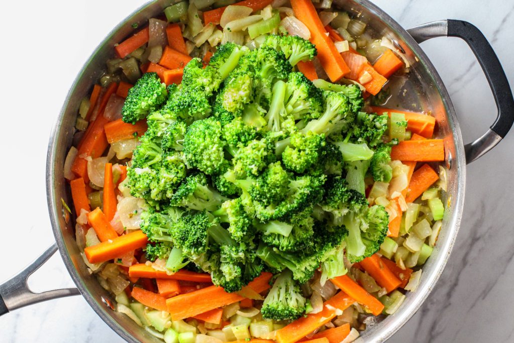 pan with broccoli on top of other stir-fry vegetables