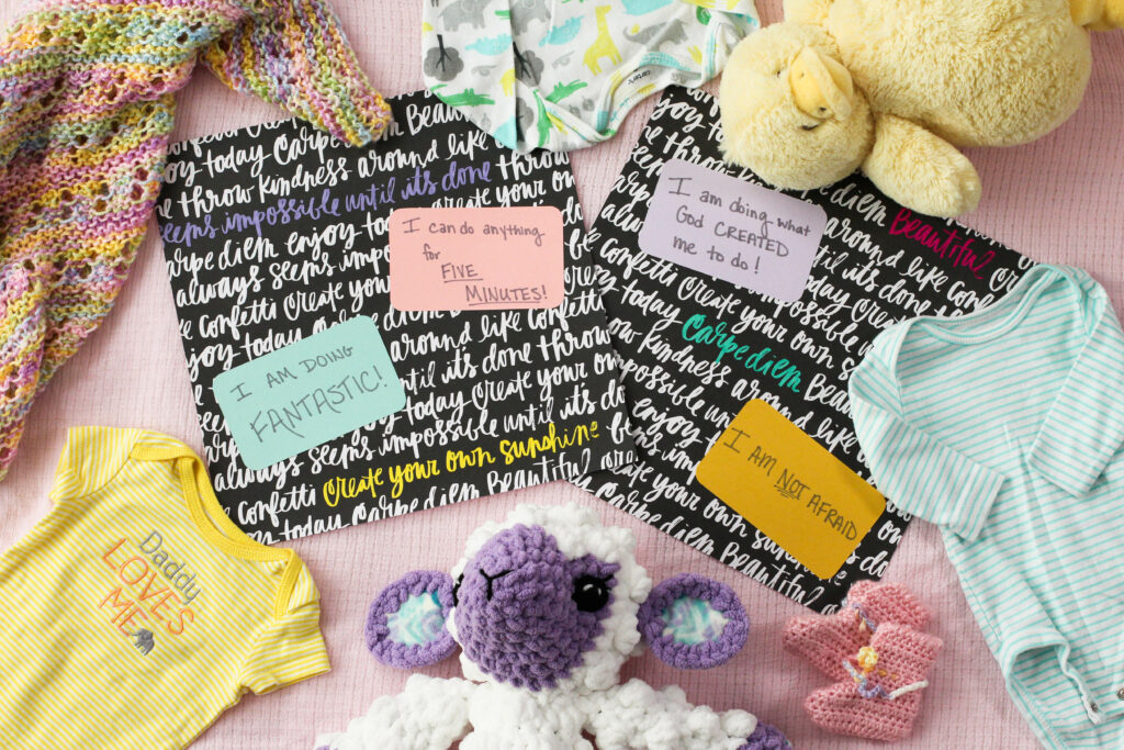 two scrapbook pages from Natural Birth scrapbook surrounded by baby items