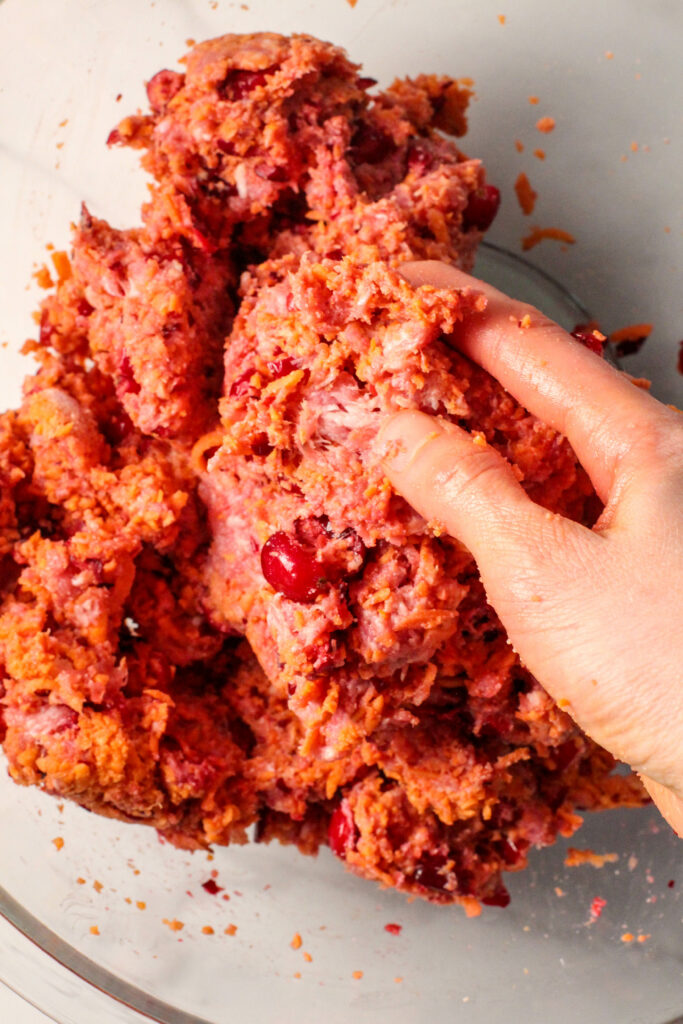 Hand mixing cranberry orange meatball mixture