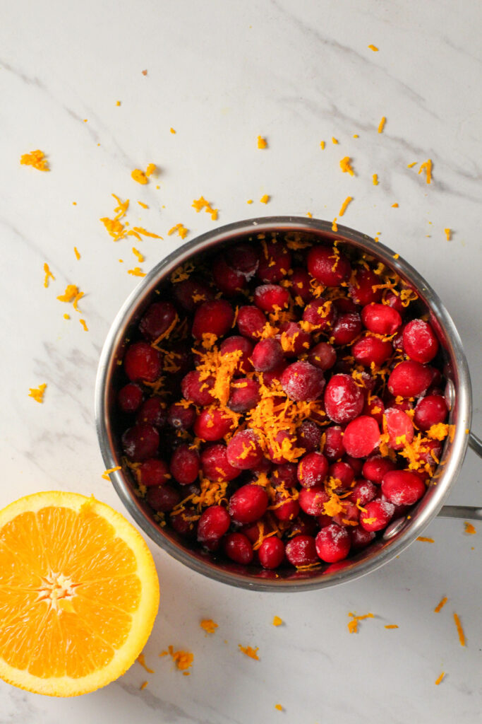 saucepan with cranberries and orange zest