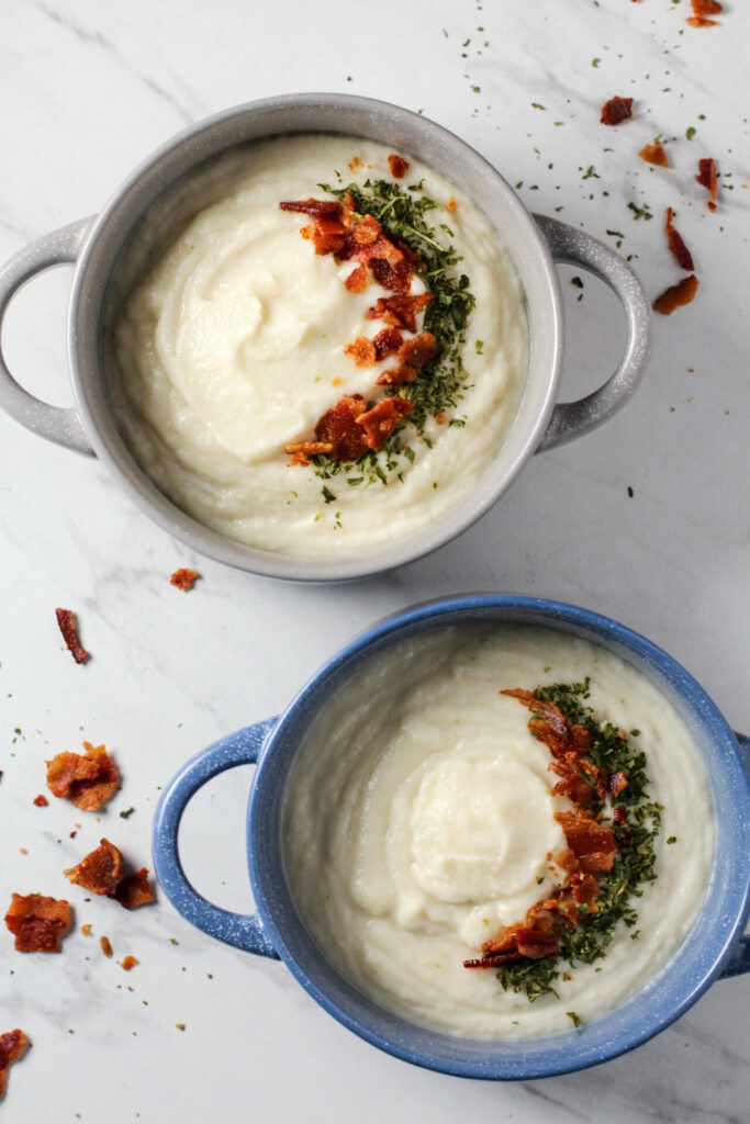 two bowls of creamy bacon cauliflower soup