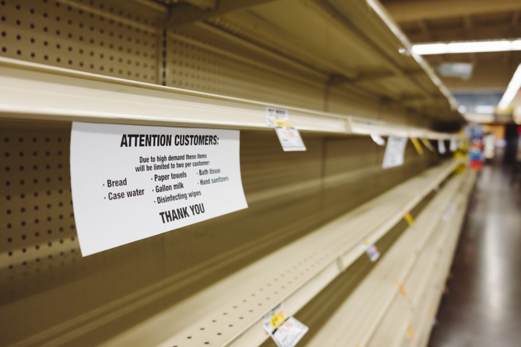 out of stock sign on grocery shelves