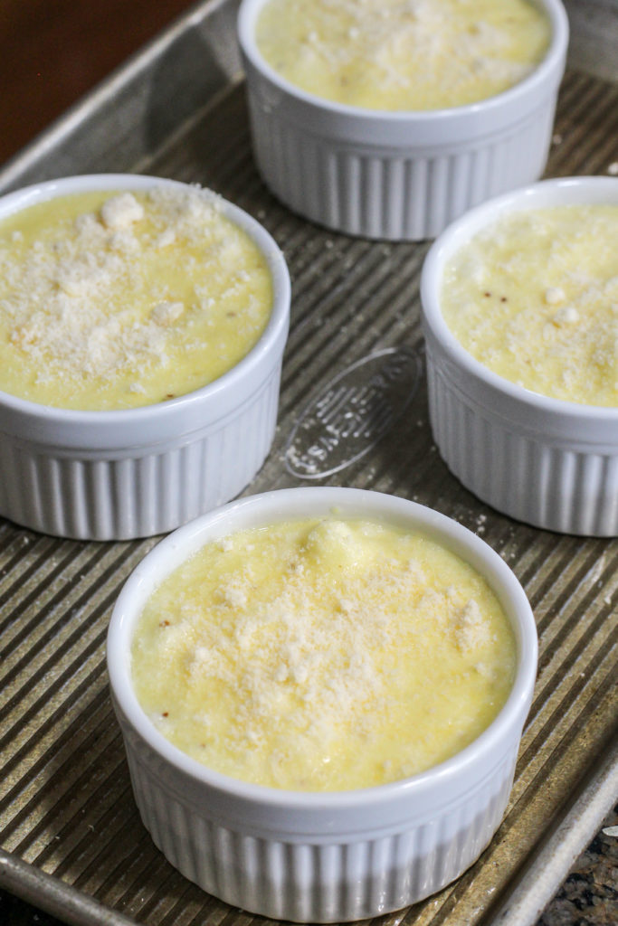 unbaked cheese souffles sprinkled with Parmesan cheese