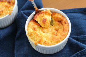spoon scooping out cheese souffle
