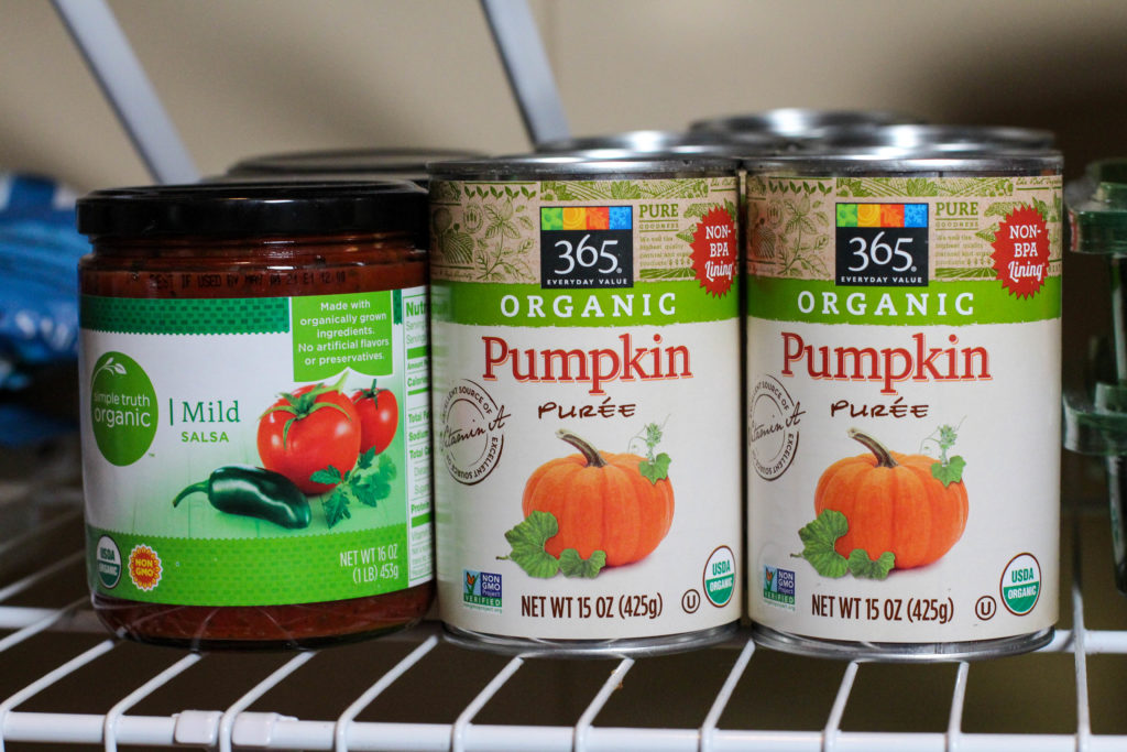 salsa and canned pumpkin on pantry shelf