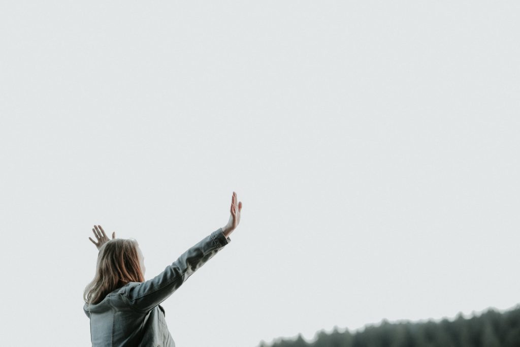 woman with hands lifted in praise