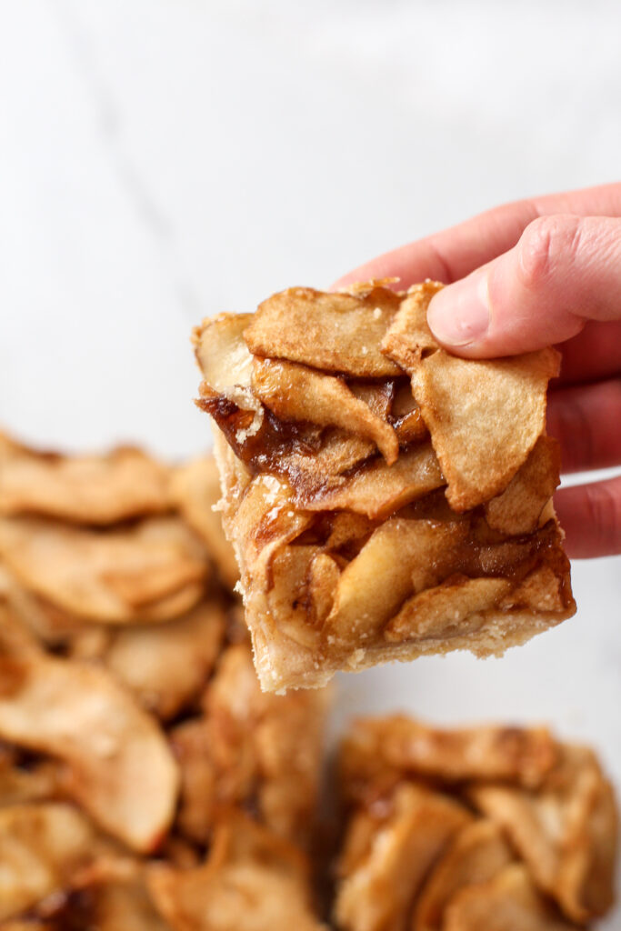 hand grabbing apple pie bar