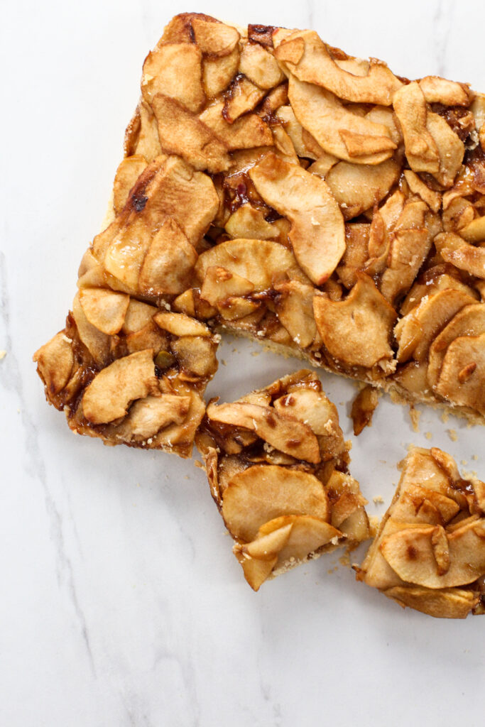 Apple pie bars with pieces cut from it