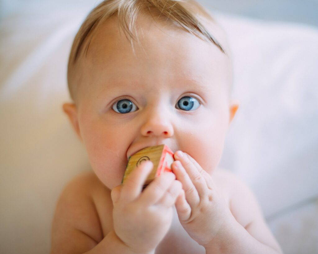 Baby with wood block in mouth