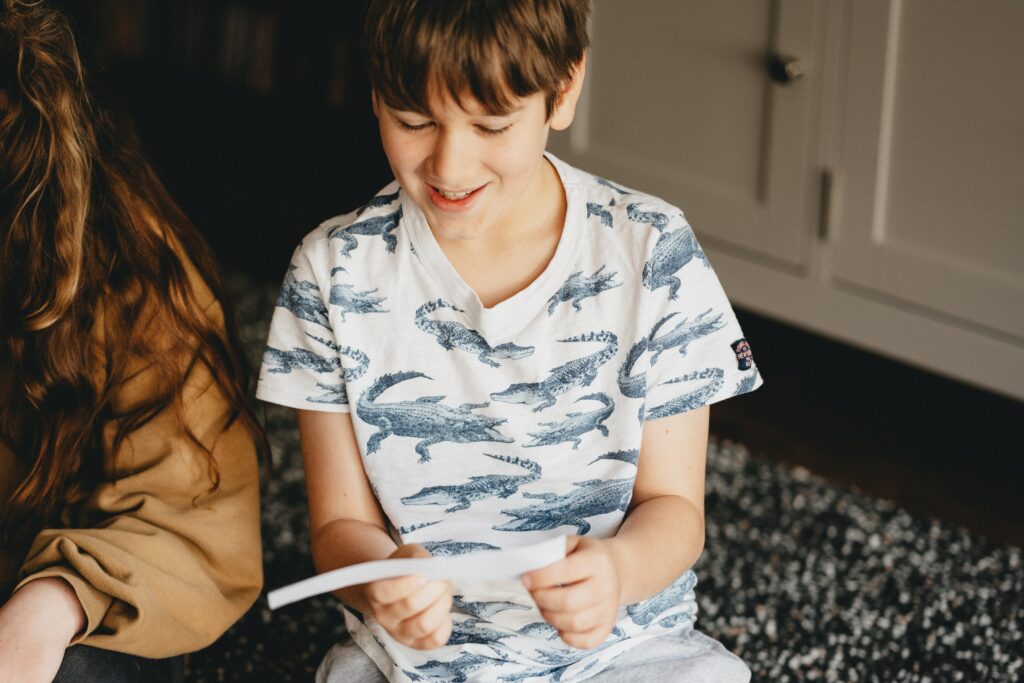 boy reading scavenger hunt clue for a new years eve at home idea