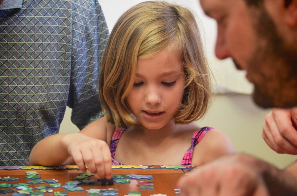 Family building a puzzle together