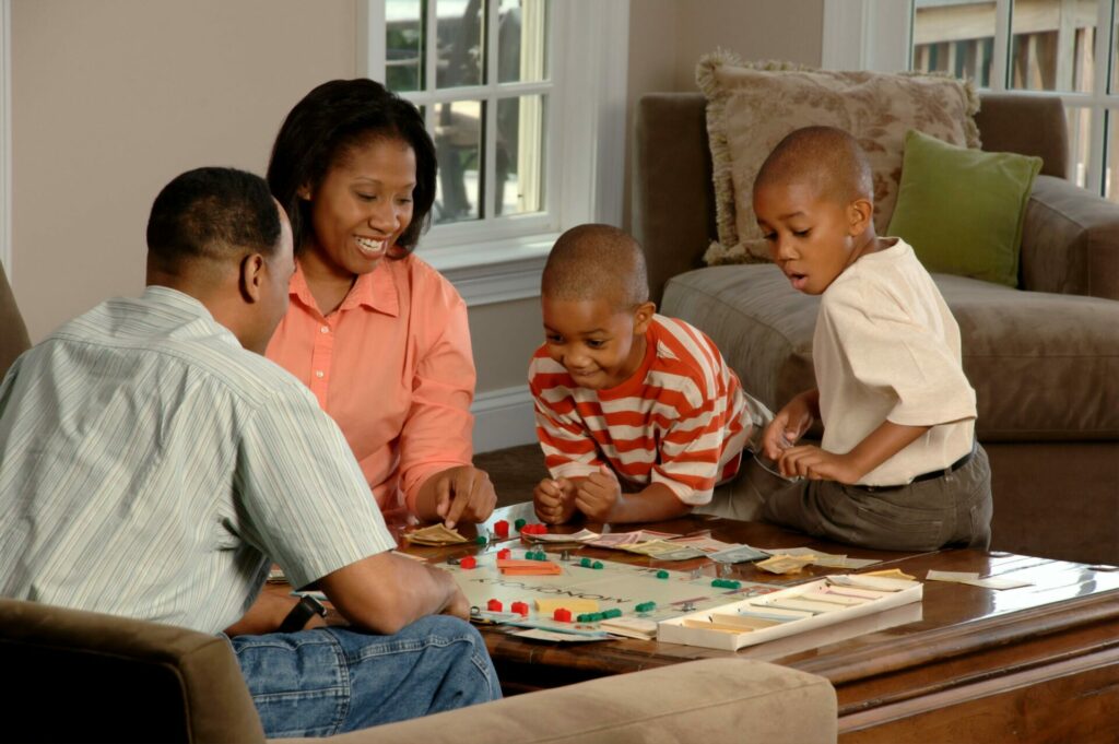 family playing board game at coffee table