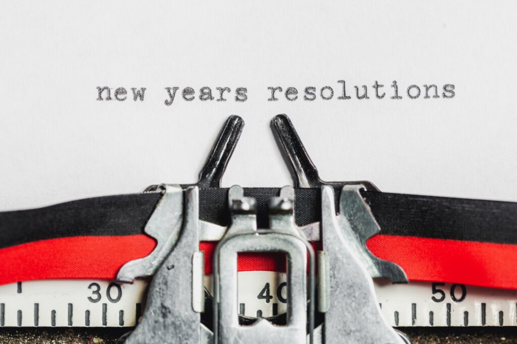 type writer with a paper that says new years resolutions