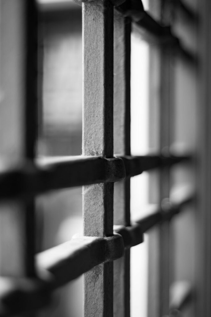 black and white photo of bars of prison