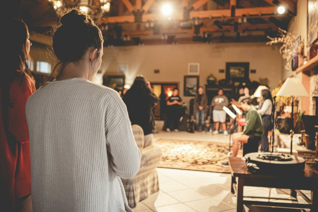 people standing in circle in a large room 