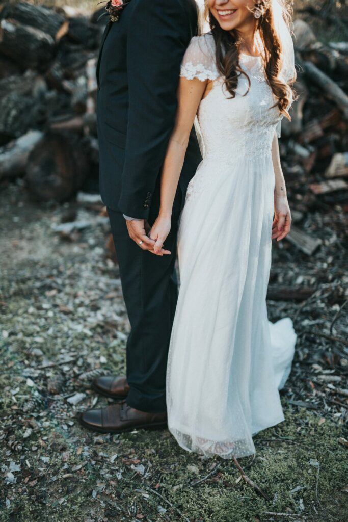 bride and groom smiling and holding hands