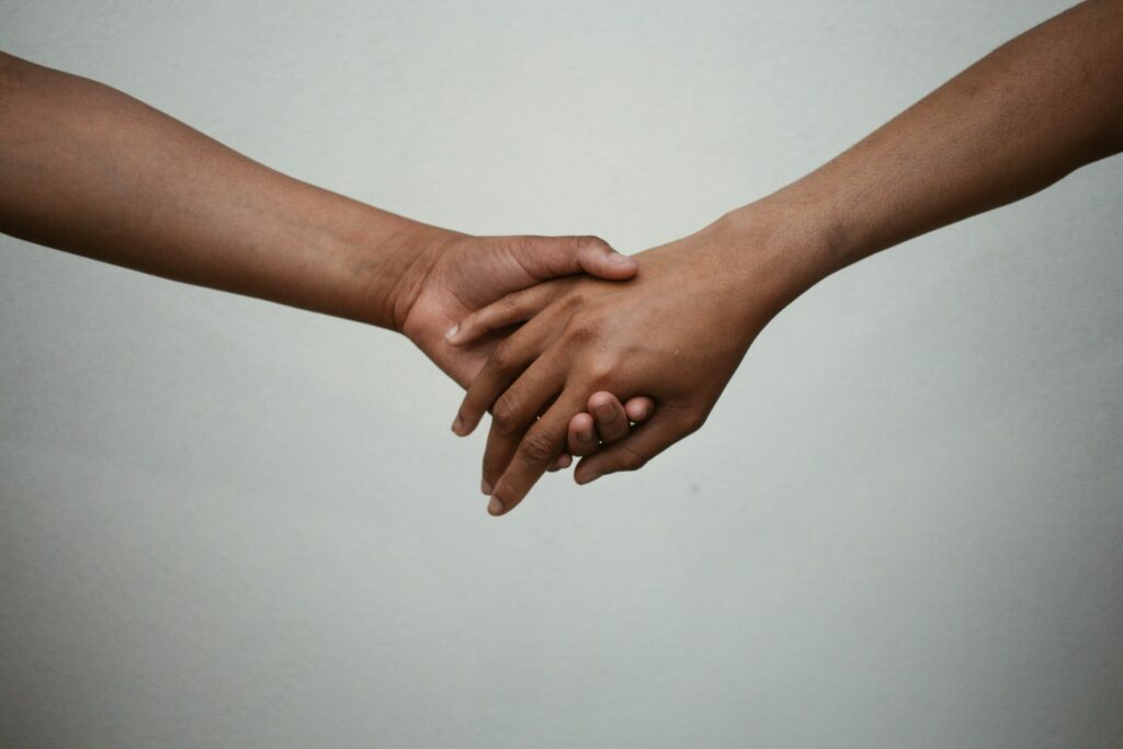 couple holding hands against white background