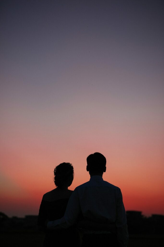 silhouette of couple against sunset
