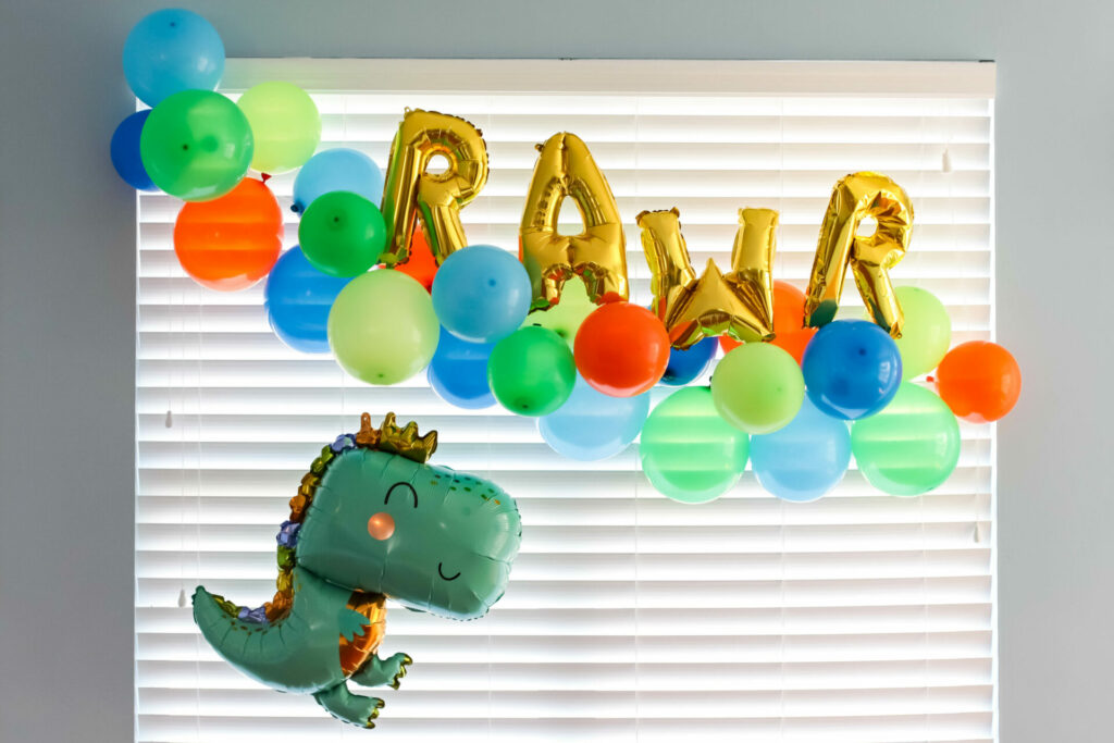 RAWR balloons with cute dinosaur for a dinosaur birthday party