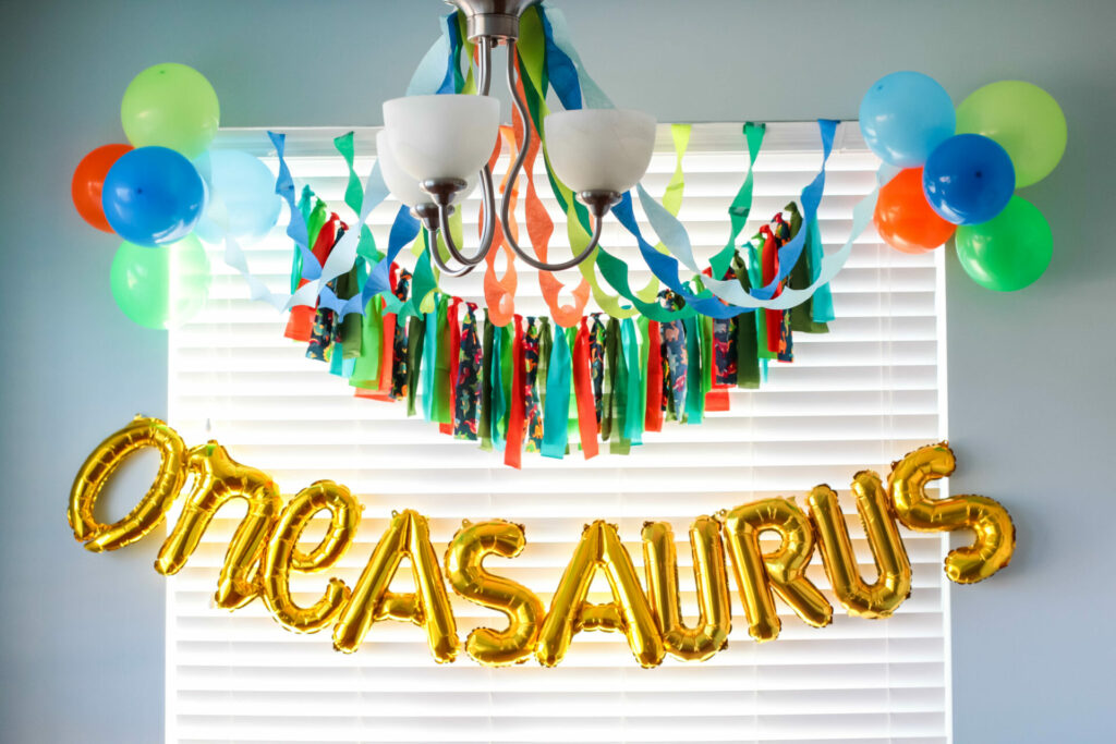 streamer, balloon, and fabric garland display for dinosaur birthday party
