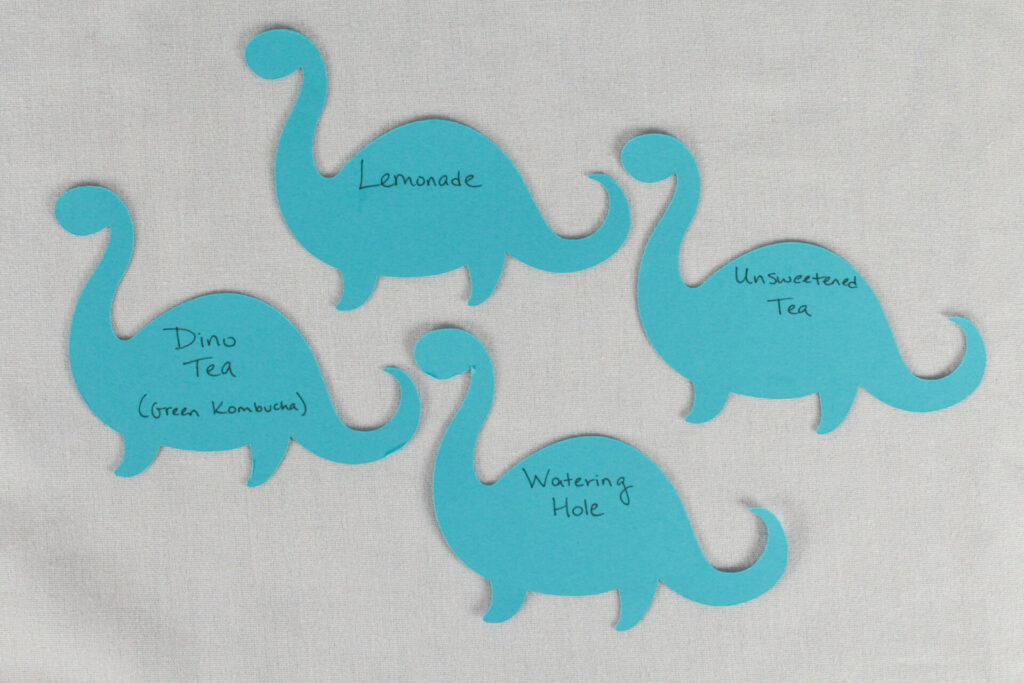 watering hole tags made from paper dinosaurs for dinosaur birthday party