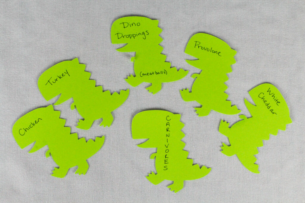 carnivore food tags made from paper dinosaurs for dinosaur birthday party