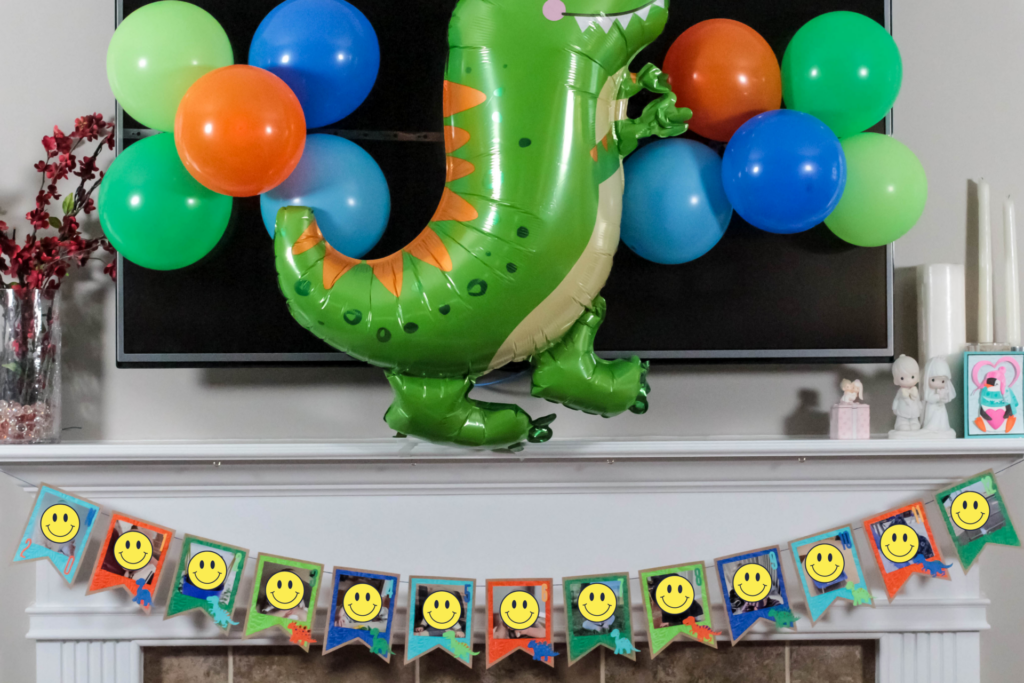 dinosaur themed photo banner across fireplace mantel for a dinosaur birthday party