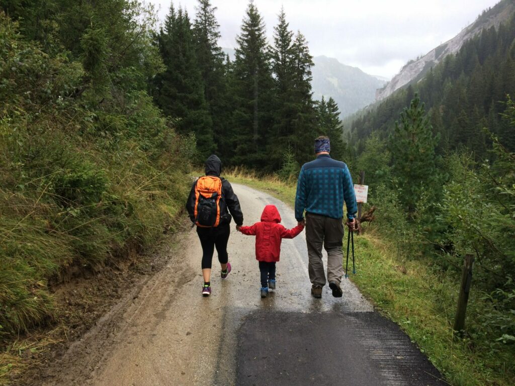 family walking down path holding hands