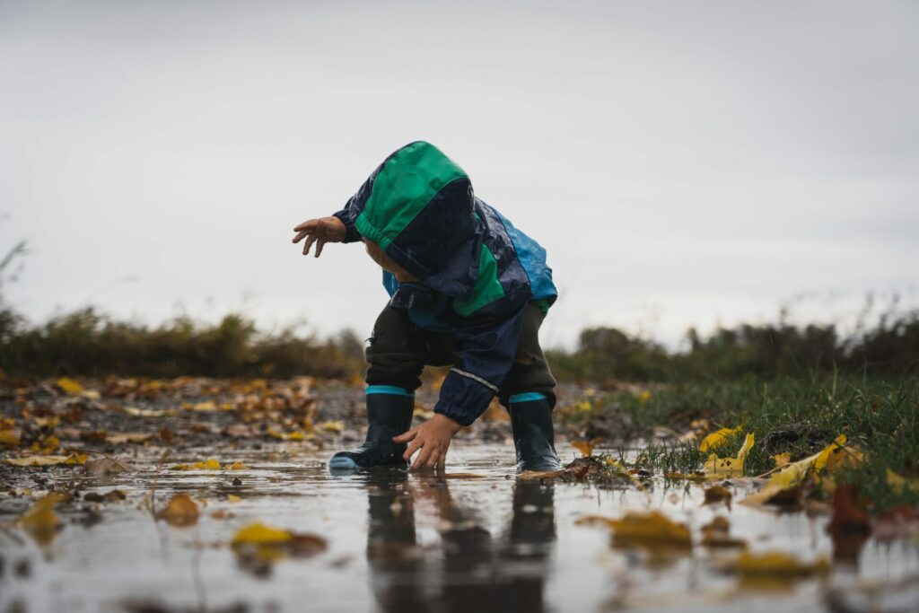 child playing in rainy weather