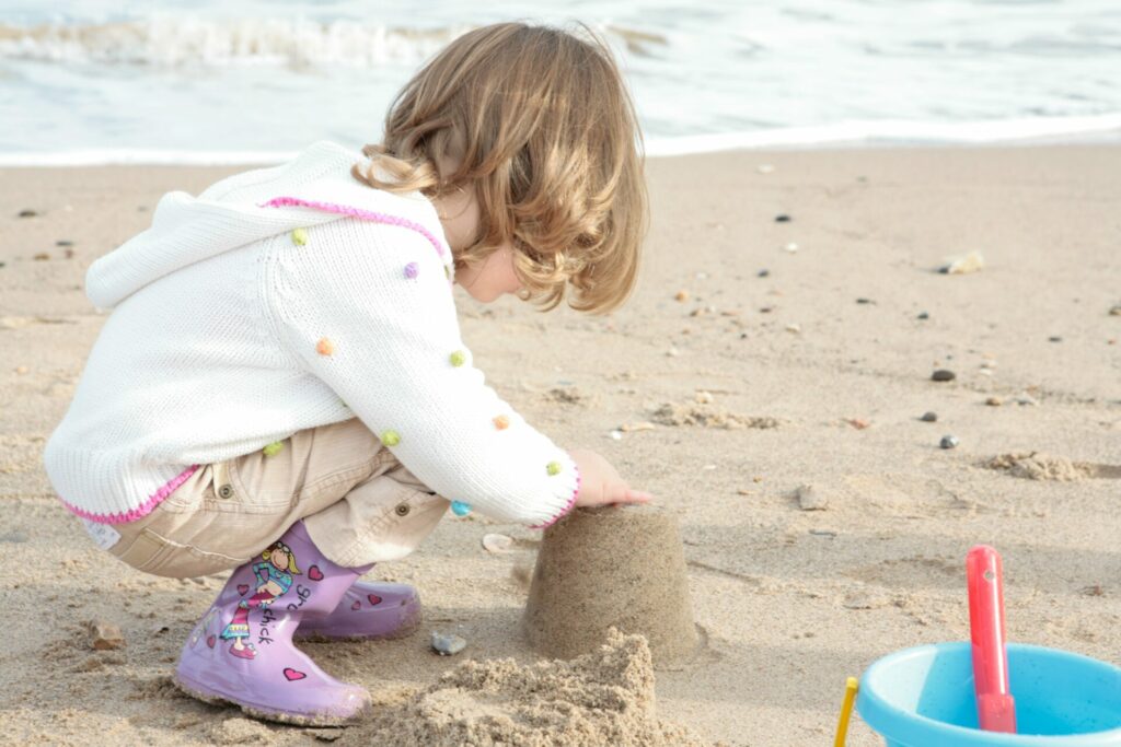 child playing in sand